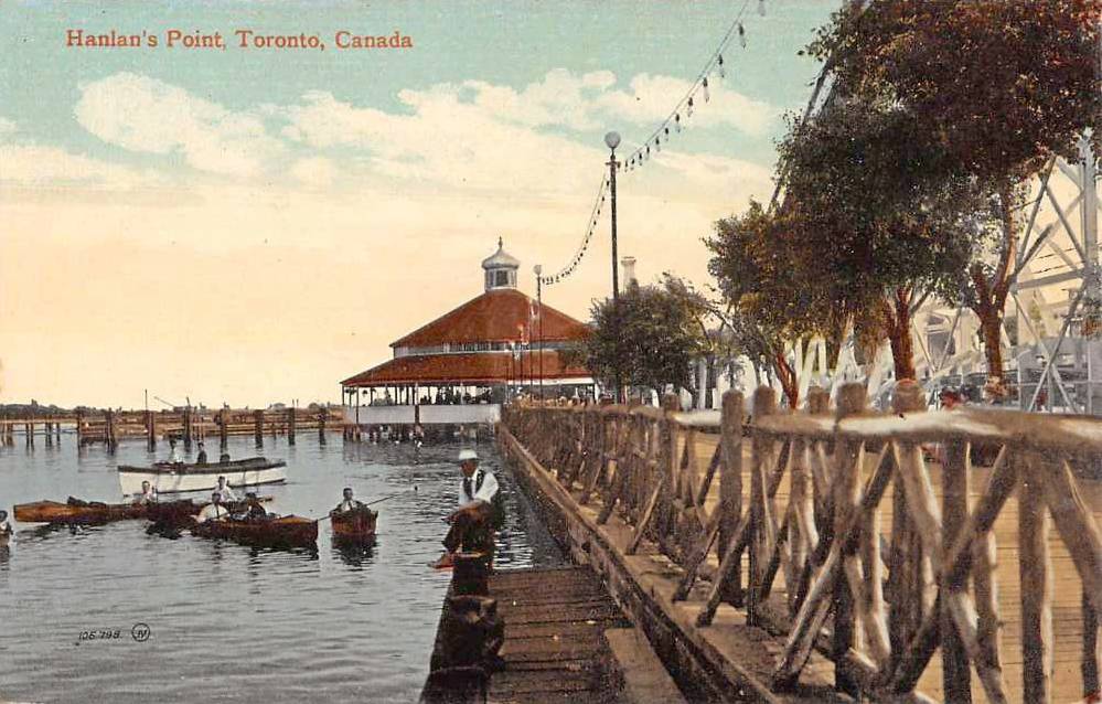 xx postcard - toronto - hanlan's point - man sitting on wharf - rowers in water - rustic fence - light string above - tinted - 1912